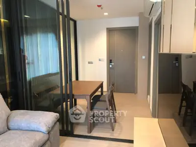 Modern apartment interior with glass partition and cozy dining area