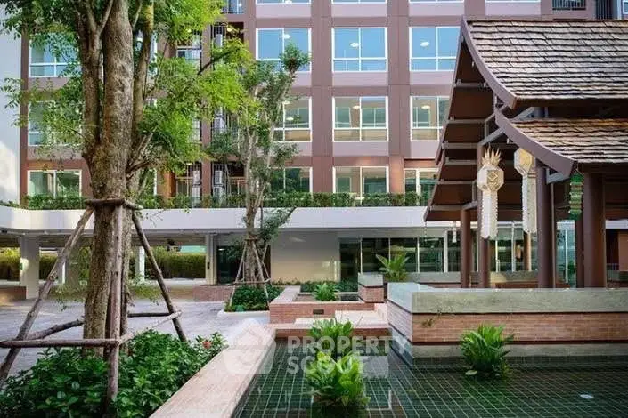 Modern building exterior with landscaped garden and water feature