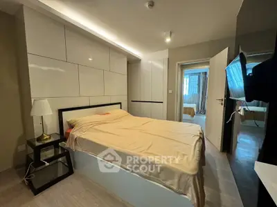 Modern bedroom with sleek design and ambient lighting in a stylish apartment.