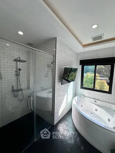 Luxurious bathroom with glass shower and jacuzzi tub, modern design.