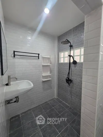 Modern bathroom with sleek shower and white subway tiles