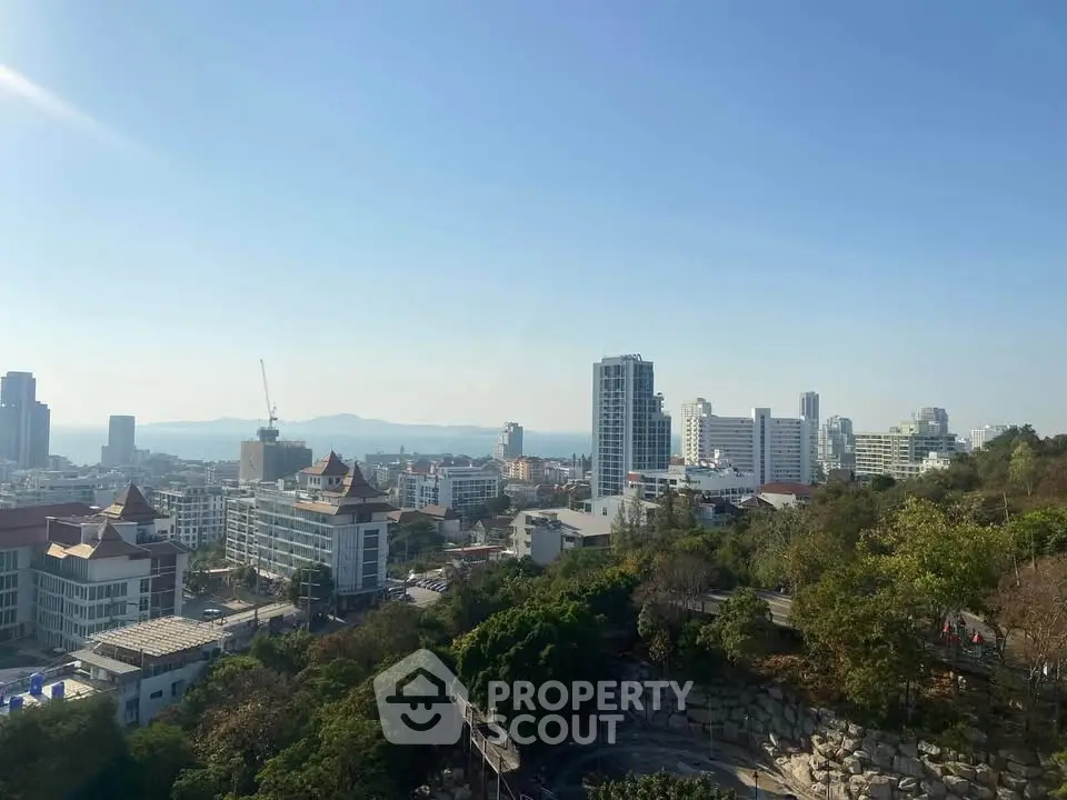 Stunning cityscape view with ocean backdrop and lush greenery