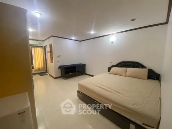 Spacious bedroom with modern furnishings and ample natural light