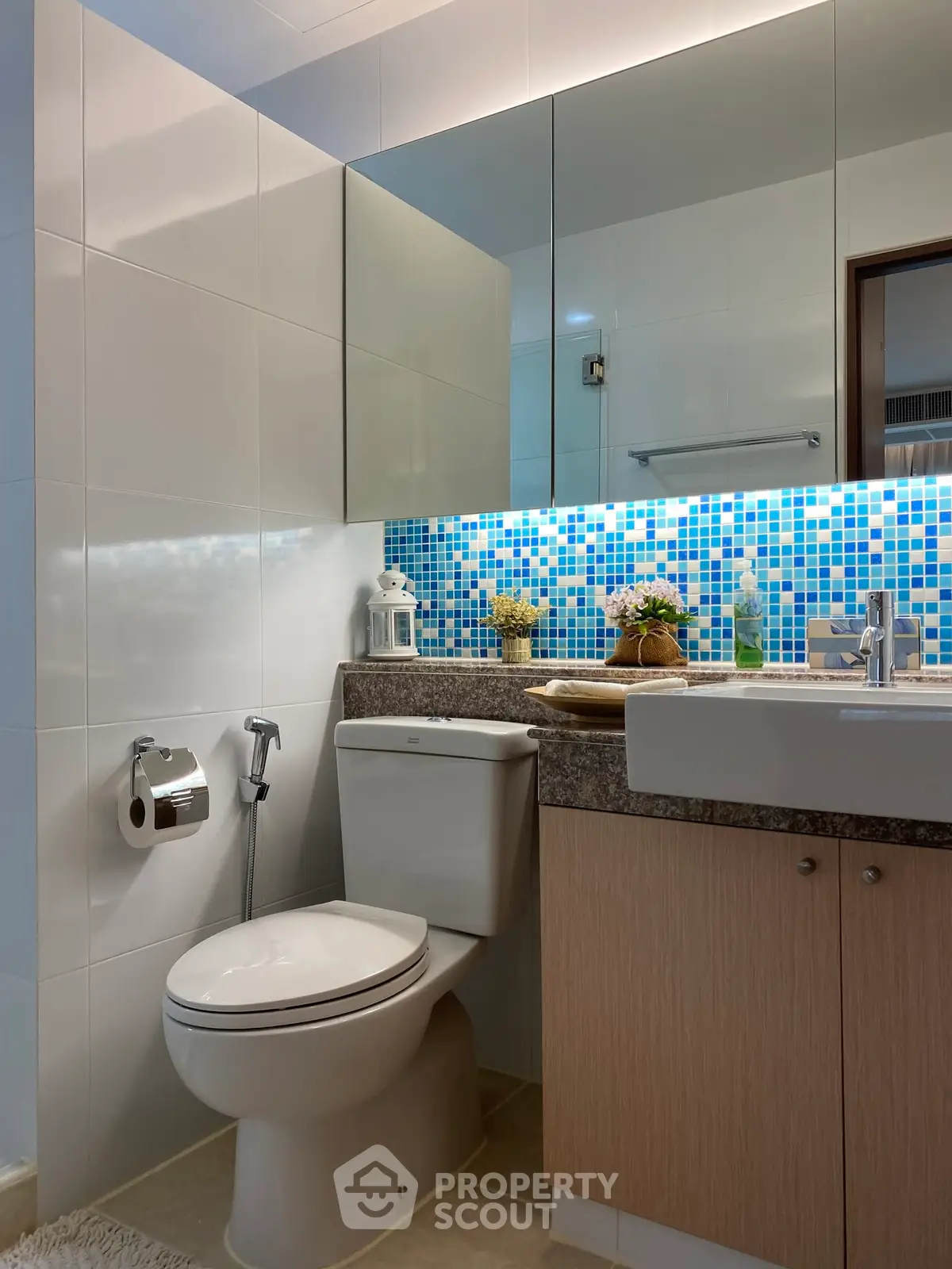 Modern bathroom with stylish mosaic tiles and sleek fixtures in a contemporary apartment.