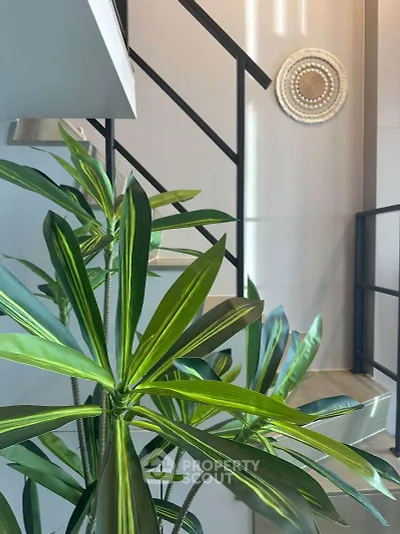Modern staircase with stylish railing and lush indoor plant decor