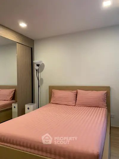 Cozy bedroom with modern design and mirrored wardrobe