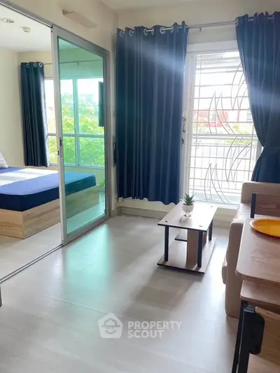 Modern apartment with bright living area and cozy bedroom, featuring large windows and stylish decor.