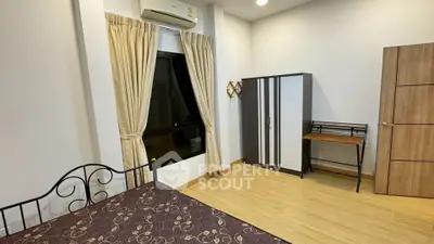 Spacious bedroom with modern furniture and natural light