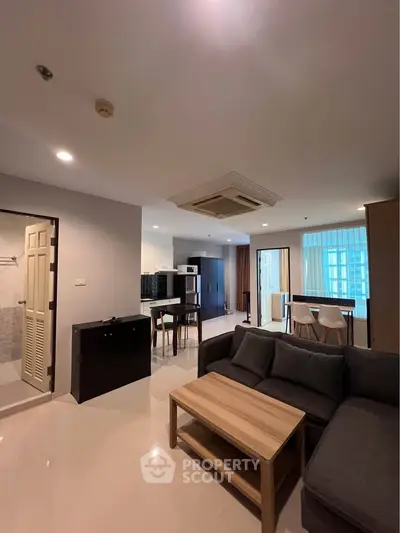 Spacious modern living room with open layout and stylish furniture in a contemporary apartment.