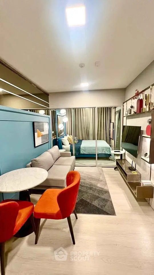 Modern studio apartment with stylish decor, featuring a cozy living area and a comfortable bed.