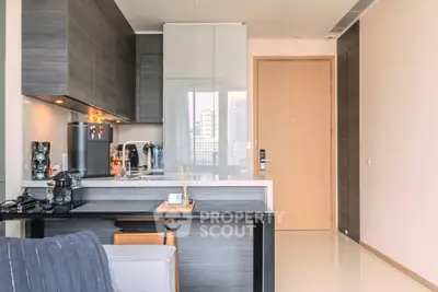 Modern kitchen with sleek cabinetry and integrated appliances in a stylish apartment.