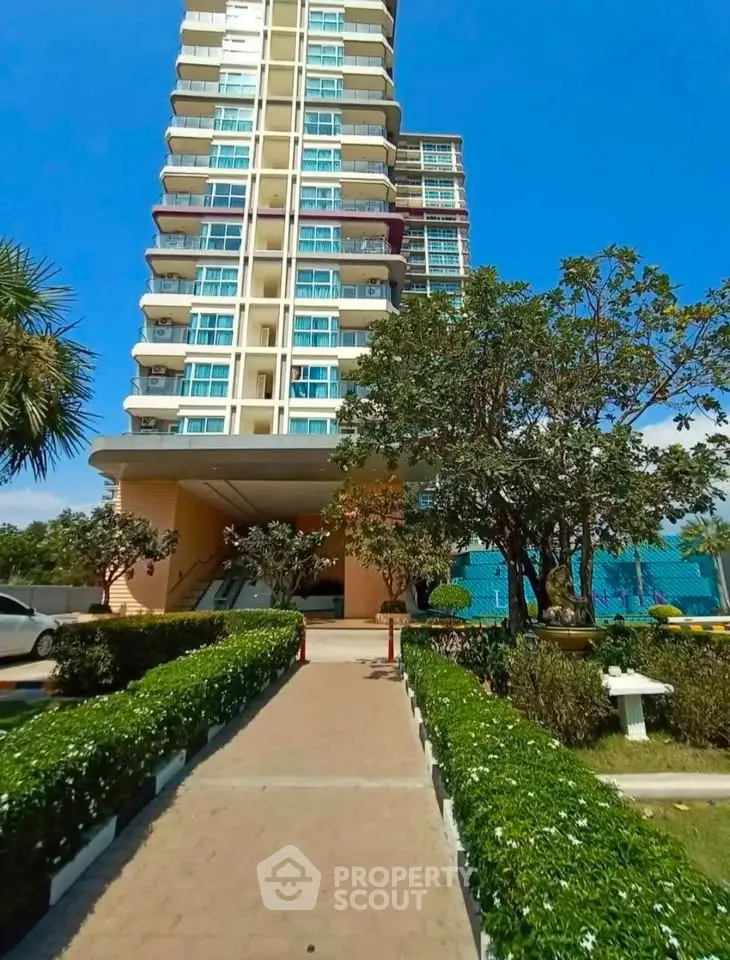 Stunning high-rise building with lush landscaping and clear blue sky