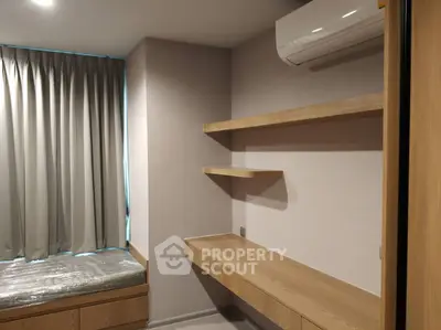 Modern minimalist bedroom with built-in wooden shelves and air conditioning.