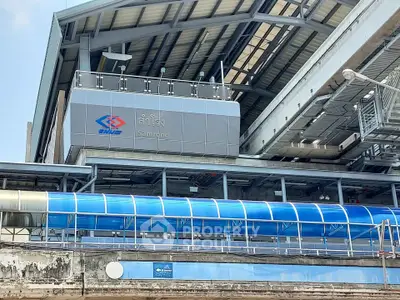 Modern train station exterior with sleek design and blue accents, showcasing urban infrastructure.