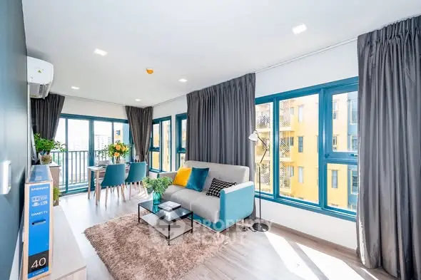 Spacious and bright living room with modern decor and large windows.