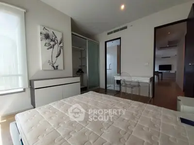 Modern bedroom with minimalist decor and large window for natural light