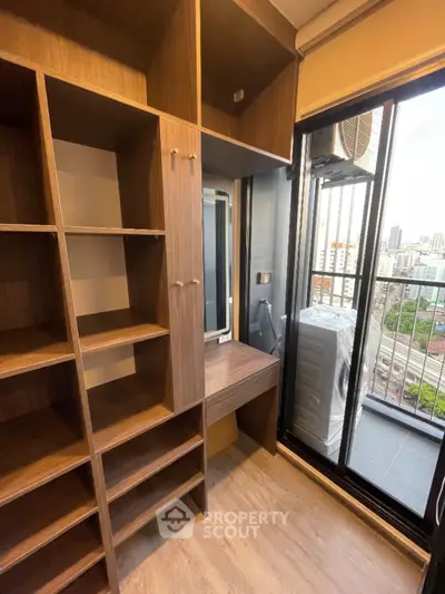 Modern storage area with wooden shelves and balcony view