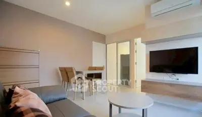 Modern living room with sleek furniture and wall-mounted TV