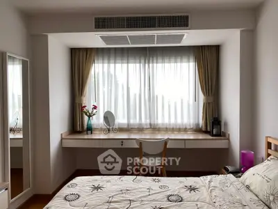 Cozy bedroom with large window, elegant curtains, and stylish decor, perfect for relaxation and comfort.