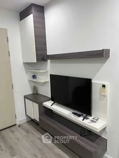 Modern living room with sleek TV unit and stylish shelving