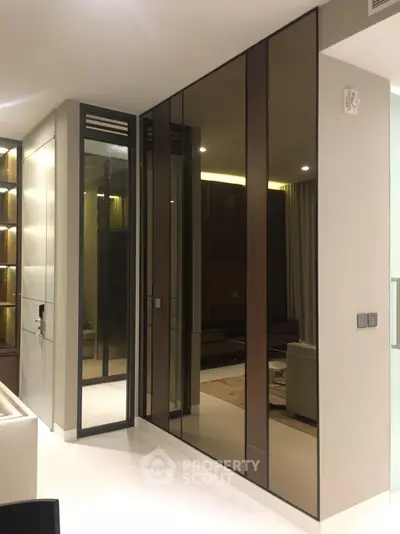 Modern living room with sleek mirrored cabinets and ambient lighting