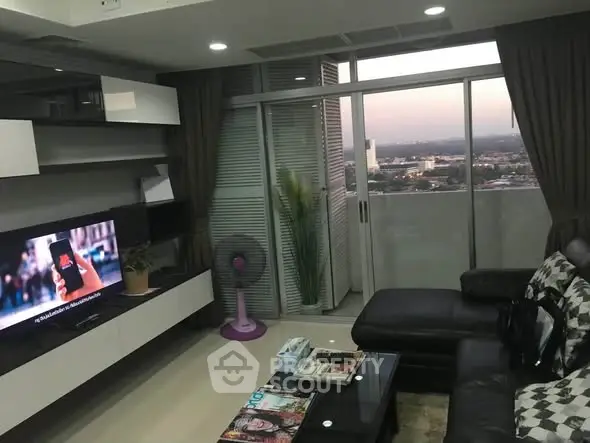Modern living room with city view and stylish decor in high-rise apartment.
