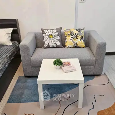 Cozy living room with modern gray sofa and stylish decor