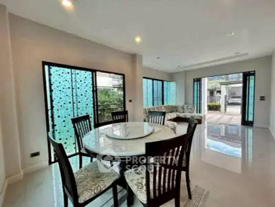 Spacious living room with elegant dining area and large windows