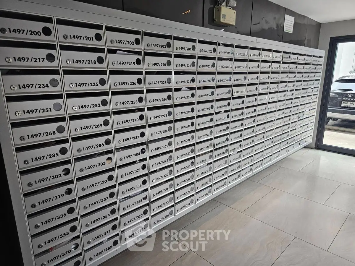 Modern apartment building mailboxes in sleek lobby area.