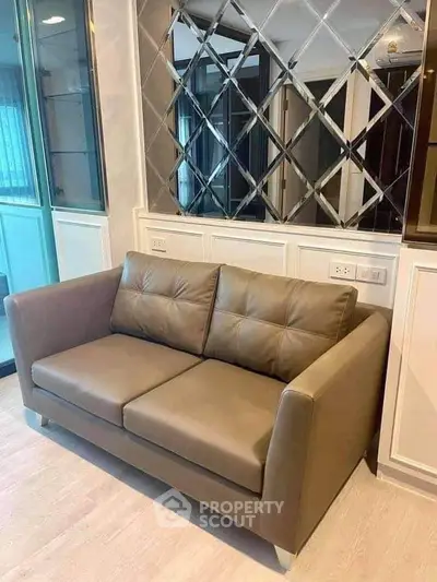 Modern living room with stylish sofa and mirrored wall accent