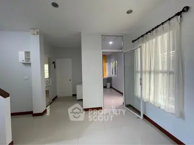 Spacious modern living room with large windows and sleek tile flooring