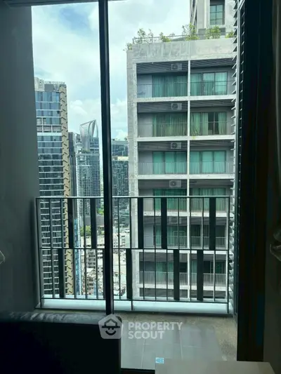 Modern apartment balcony with cityscape view, featuring sleek high-rise buildings and urban skyline.