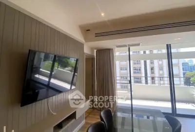 Modern living room with wall-mounted TV and large balcony view