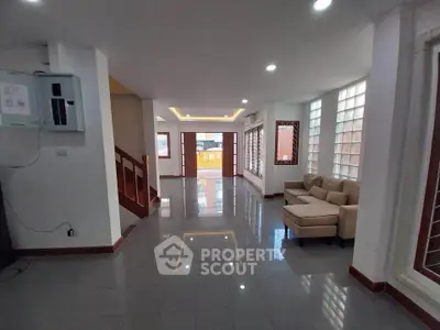 Spacious modern living room with sleek tile flooring and cozy seating area