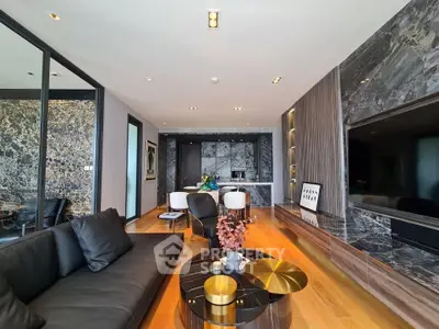 Luxurious modern living room with marble accents and sleek black furniture, perfect for stylish urban living.