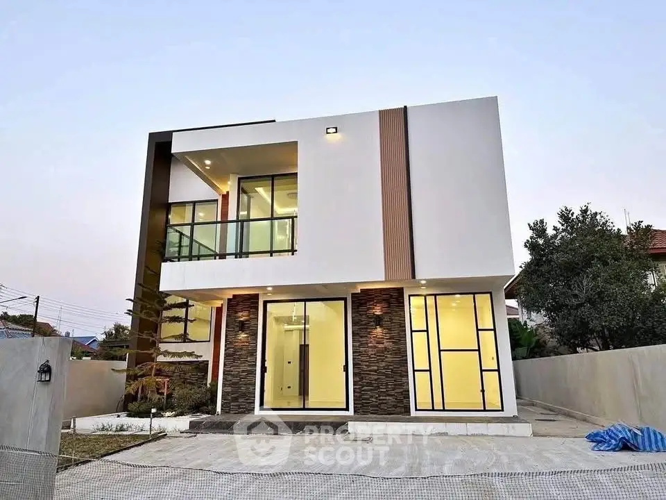 Modern two-story house with sleek design and large windows, perfect for contemporary living.