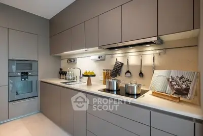 Modern kitchen with sleek cabinetry and built-in appliances, featuring a minimalist design.