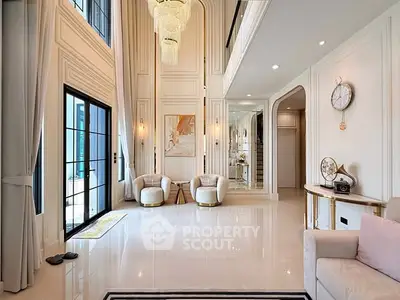 Luxurious high-ceiling living room with elegant decor and large windows