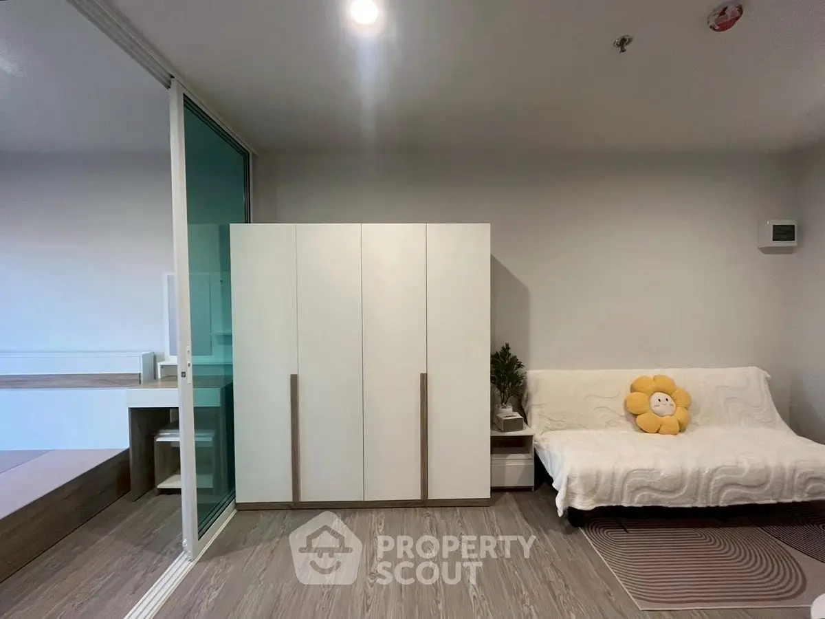 Modern living room with sleek wardrobe and cozy sofa in stylish apartment