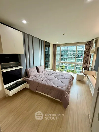 Modern bedroom with large windows and stylish decor in a high-rise apartment.