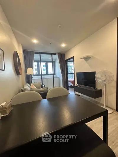 Modern living room with stylish decor and large window view