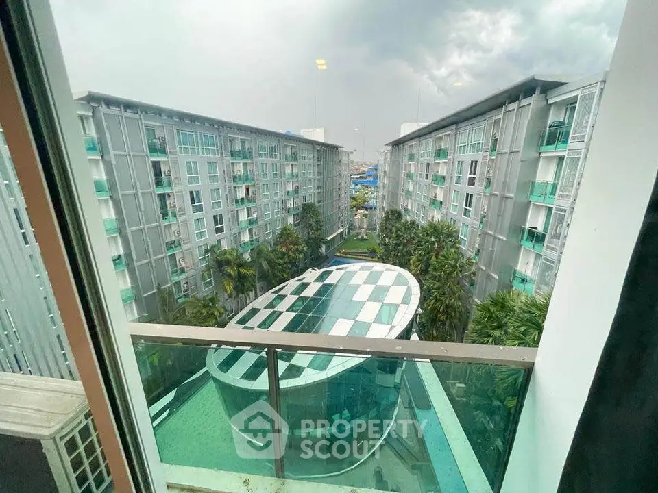 Stunning view of modern apartment complex with unique architectural design and lush greenery.