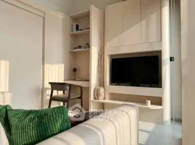 Modern living room with built-in TV unit and cozy seating area, perfect for relaxation.