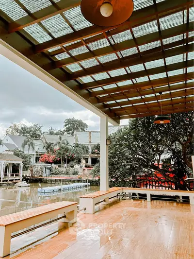 Stunning waterfront patio with wooden pergola and scenic views