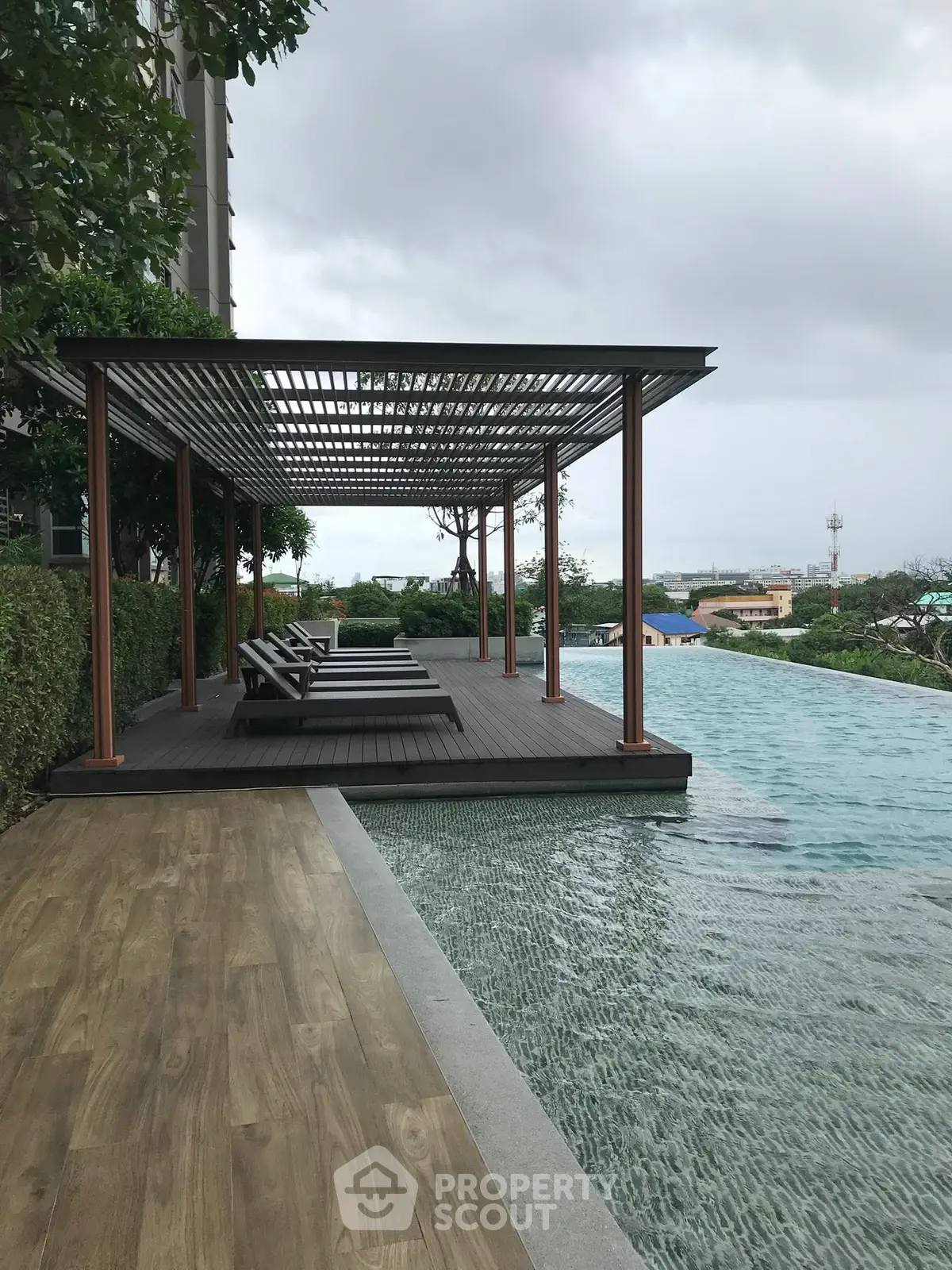 Luxurious poolside area with modern pergola and stunning view