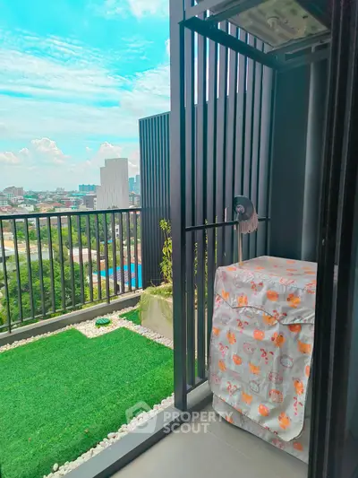 Charming balcony with city view and covered washing machine, perfect for urban living.