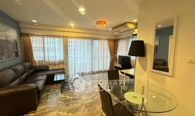 Spacious living room with modern decor and large windows for natural light.