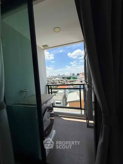 Charming balcony with city view and washing machine, perfect for urban living.