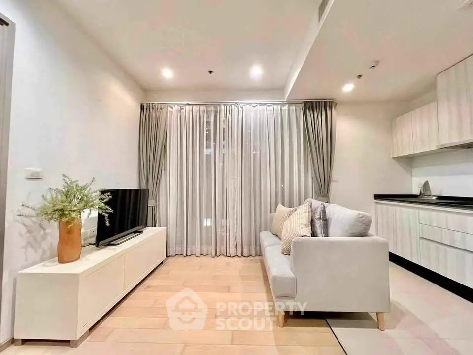 Modern living room with sleek design, featuring a cozy sofa, TV unit, and elegant curtains in a bright, airy space.