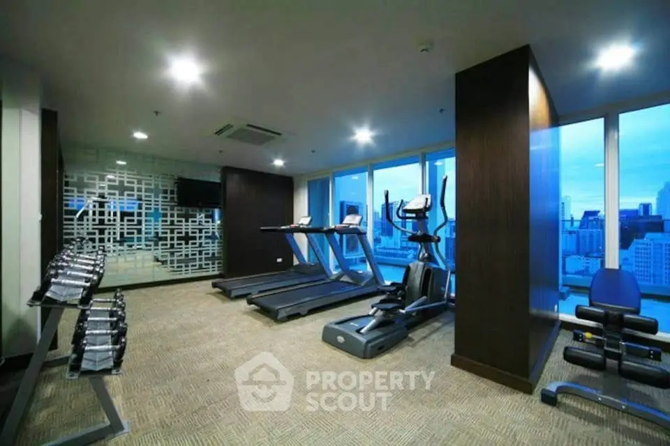Modern gym with city view in luxury apartment building